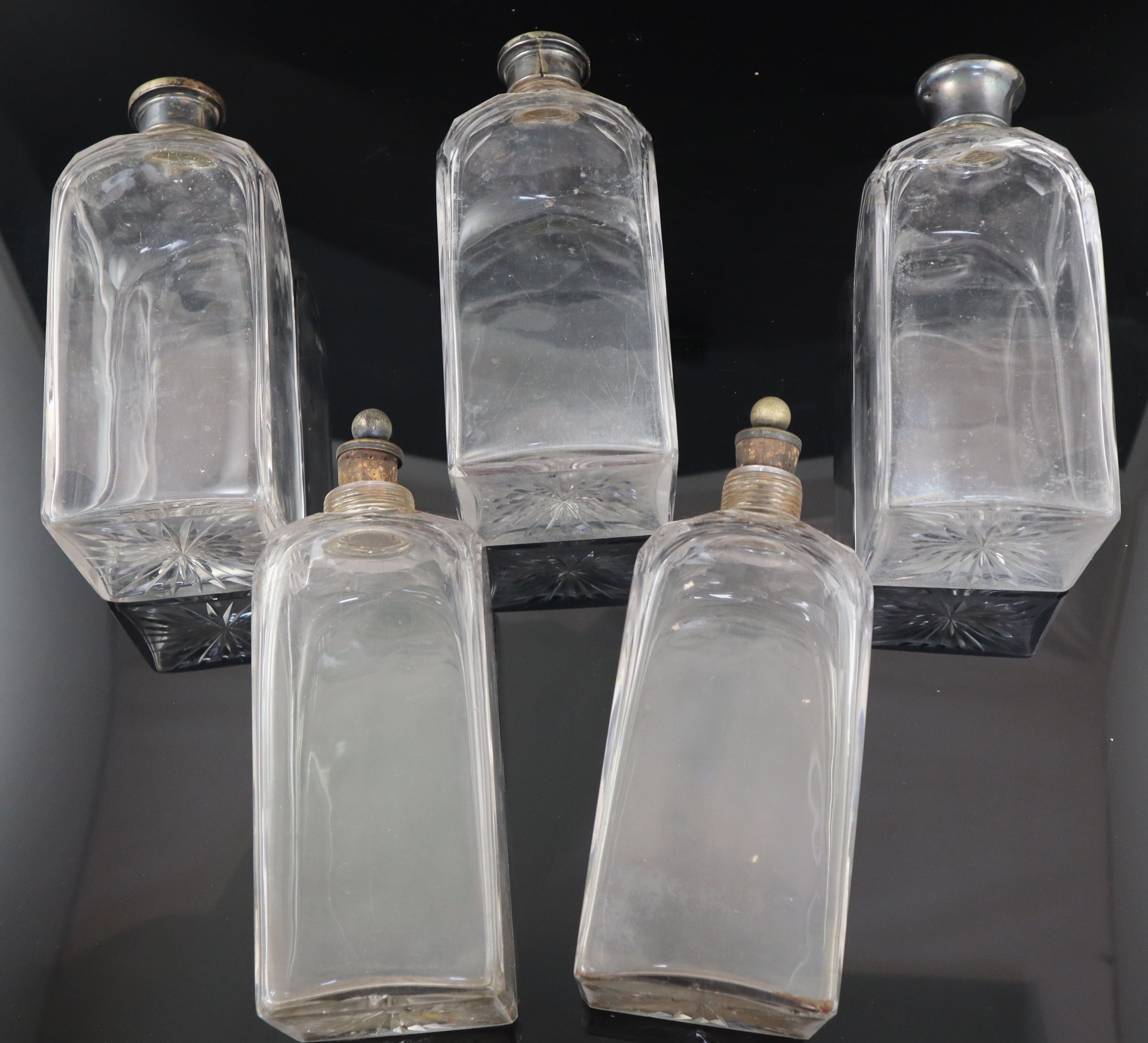 A part set of five early 19th century cut glass decanters, 23cm